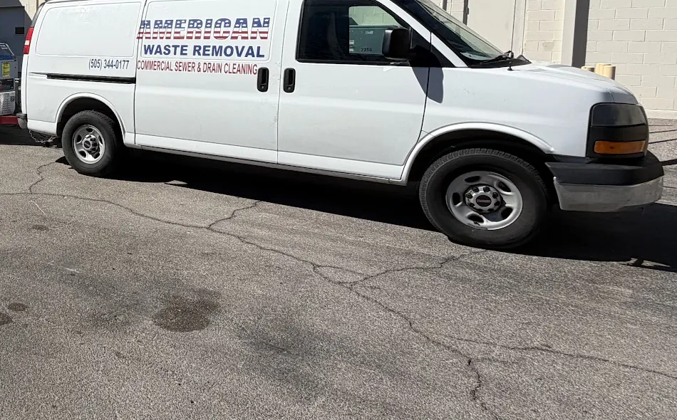 AWR service van lettered American Waste Removal, Commercial Sewer and Drain Cleaning, with the dispatch number on the door