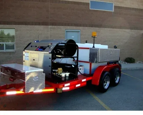 Red trailer-mounted hot-jet unit with stainless tool boxes